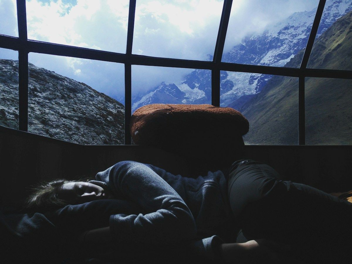 Person sleeping inside a glass igloo