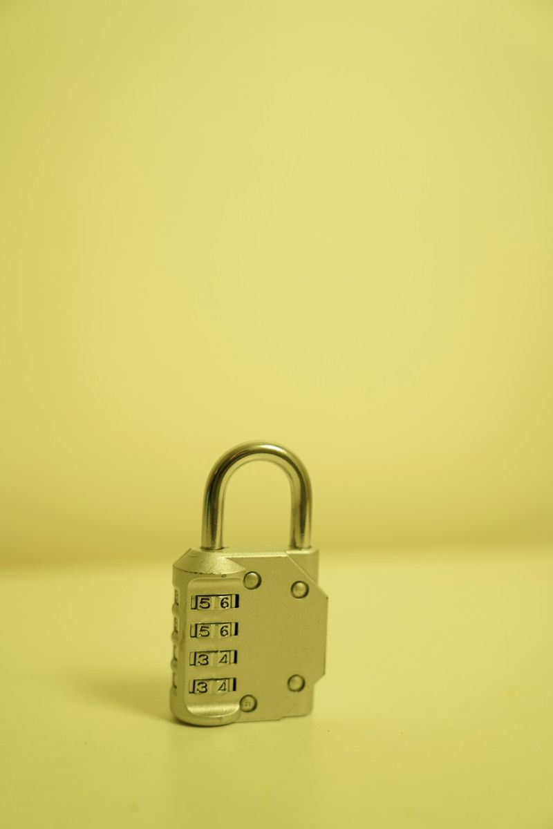 Combination padlock on a yellow tabletop.