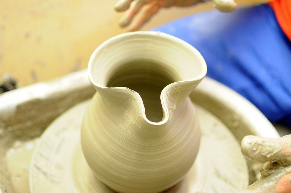 Artisan shaping a vase on a pottery wheel