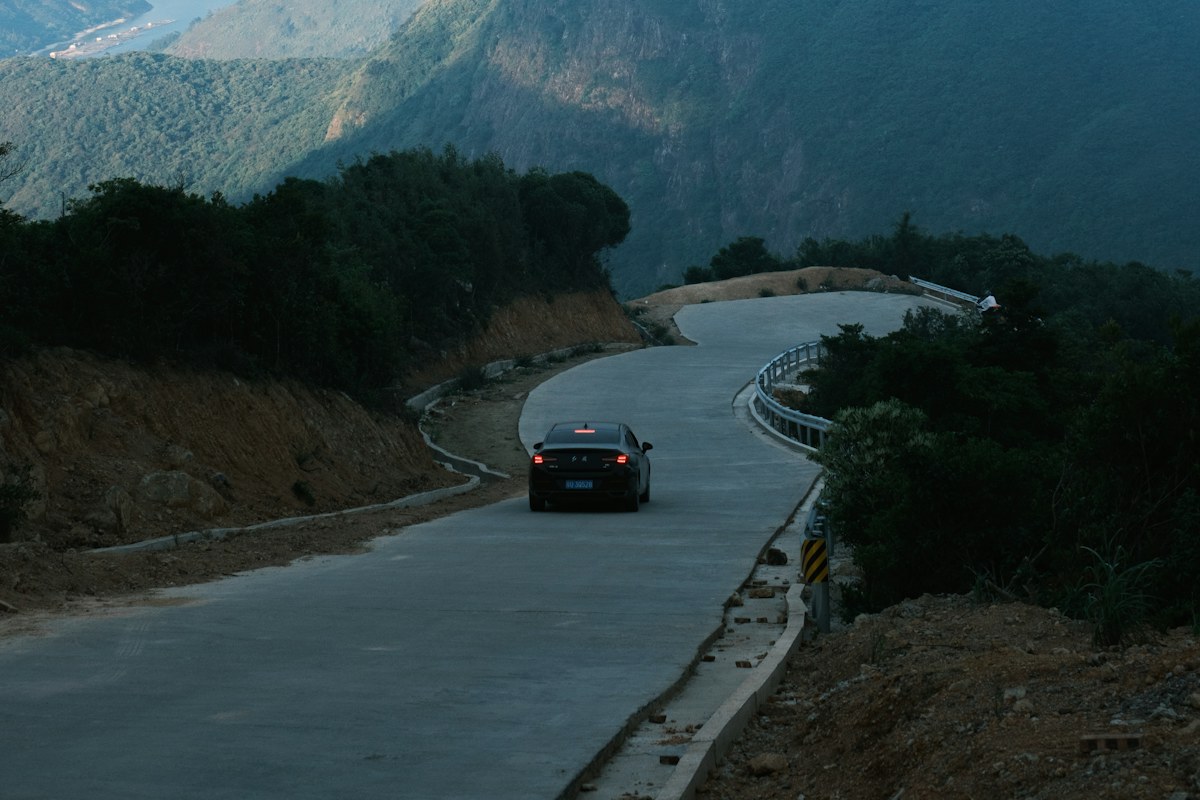 A car traveling along a winding scenic mountain road